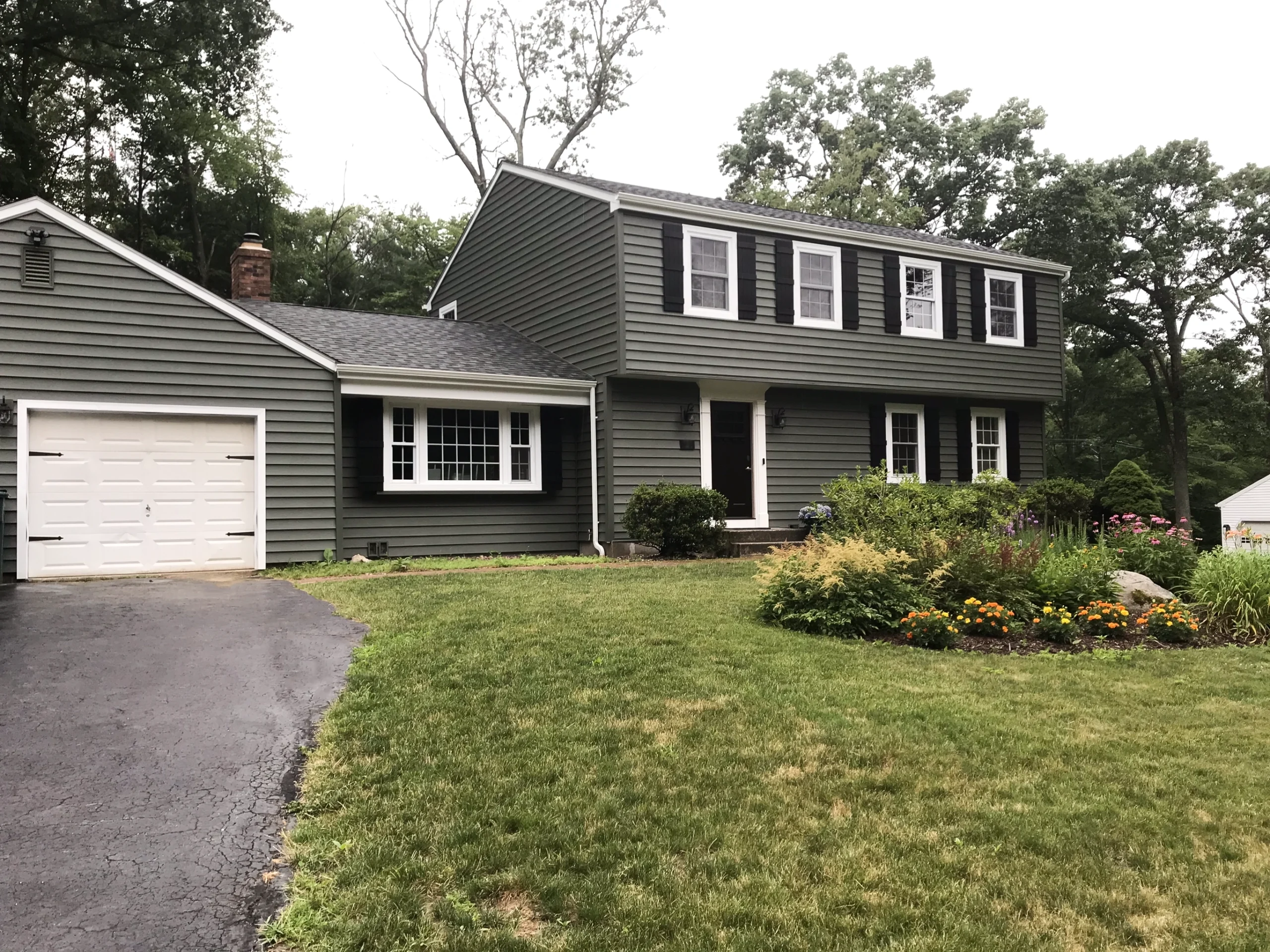 Dark green vinyl siding replacement, and IKO roof shingle replacement